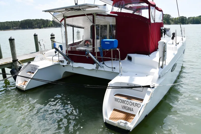 Lil Anna Yacht Photos Pics 2014 Fountaine Pajot Mahe 36 Evolution catamaran docked, featuring red canopy and Virginia registration.