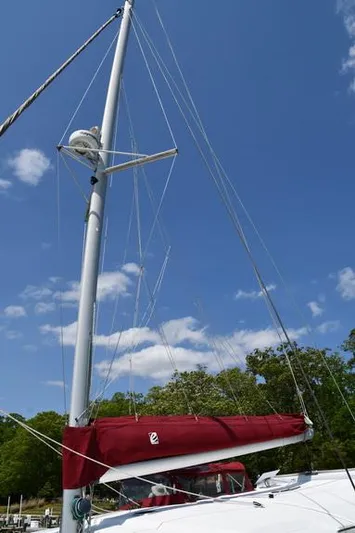 Lil Anna Yacht Photos Pics Sailboat mast and red sail on 2014 Fountaine Pajot Mahe 36 Evolution under blue sky.