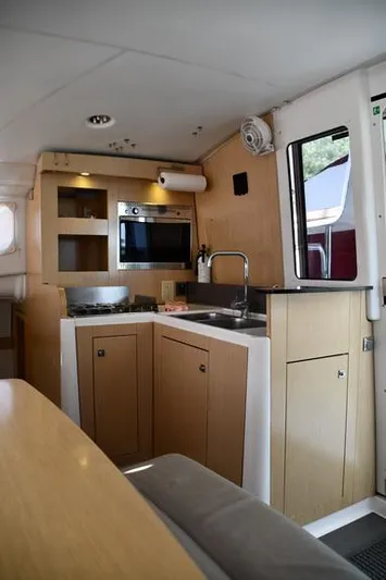 Lil Anna Yacht Photos Pics Interior of 2014 Fountaine Pajot Mahe 36 Evolution yacht, featuring a compact kitchen area.