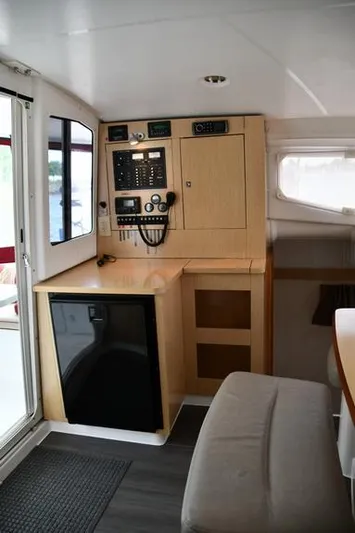 Lil Anna Yacht Photos Pics Interior of 2014 Fountaine Pajot Mahe 36 Evolution catamaran, featuring navigation controls and compact fridge.