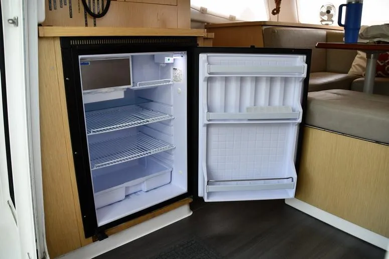 Lil Anna Yacht Photos Pics Open fridge inside 2014 Fountaine Pajot Mahe 36 Evolution catamaran, showcasing interior storage.