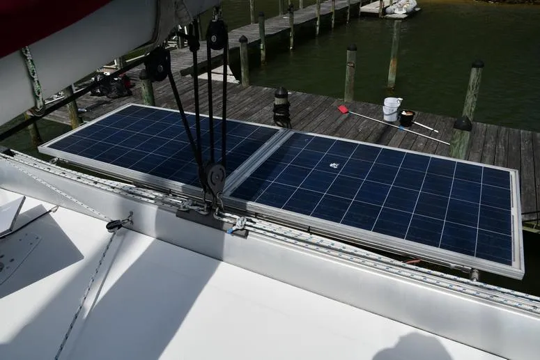 Lil Anna Yacht Photos Pics Solar panels on a 2014 Fountaine Pajot Mahe 36 Evolution catamaran docked at a marina.