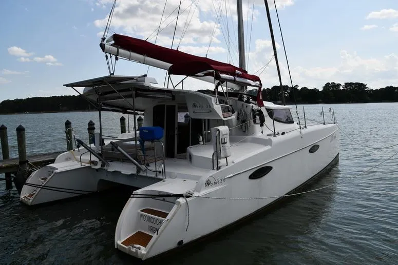 Lil Anna Yacht Photos Pics 2014 Fountaine Pajot Mahe 36 Evolution catamaran docked on calm water.