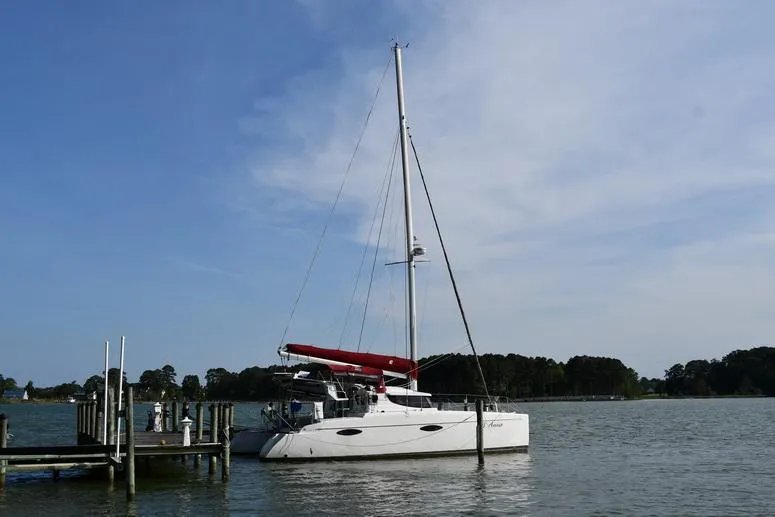 Lil Anna Yacht Photos Pics 2014 Fountaine Pajot Mahe 36 Evolution catamaran docked on calm water under clear sky.