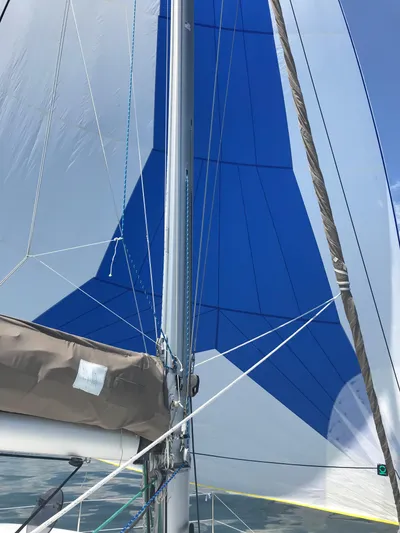 Lil Anna Yacht Photos Pics Sailing on a 2014 Fountaine Pajot Mahe 36 Evolution with blue and white sails.