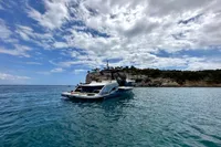2022 Solaris Power 44 Open yacht on serene blue waters under a partly cloudy sky.