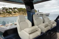 Luxurious seating on a 2022 Solaris Power 44 Open yacht, with scenic coastal backdrop.