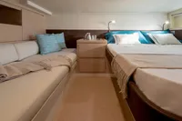Luxurious interior of 2022 Solaris Power 44 Open yacht with cozy bed and seating area.