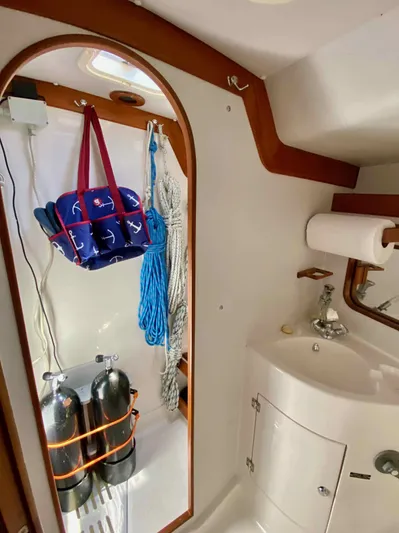Navicula Yacht Photos Pics Interior of 2001 J Boats J/46 sailboat with sink, storage, and nautical decor.