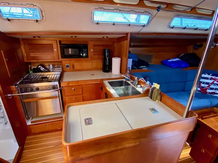 Navicula Yacht Photos Pics Interior of 2001 J Boats J/46 yacht with kitchen and seating area.