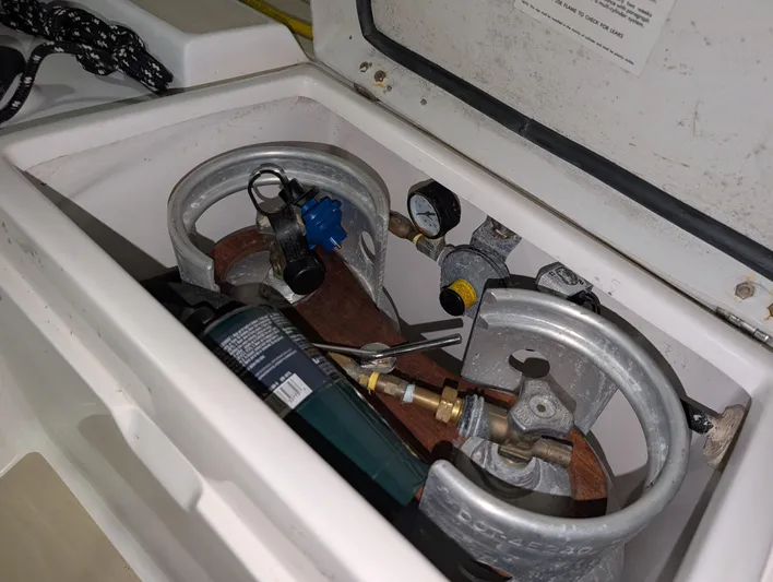 Navicula Yacht Photos Pics Propane storage compartment on a 2001 J Boats J/46 sailboat, featuring gas cylinders and gauges.