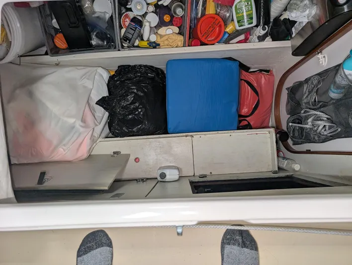 Navicula Yacht Photos Pics Storage compartment in a 2001 J Boats J/46, filled with various items and supplies.