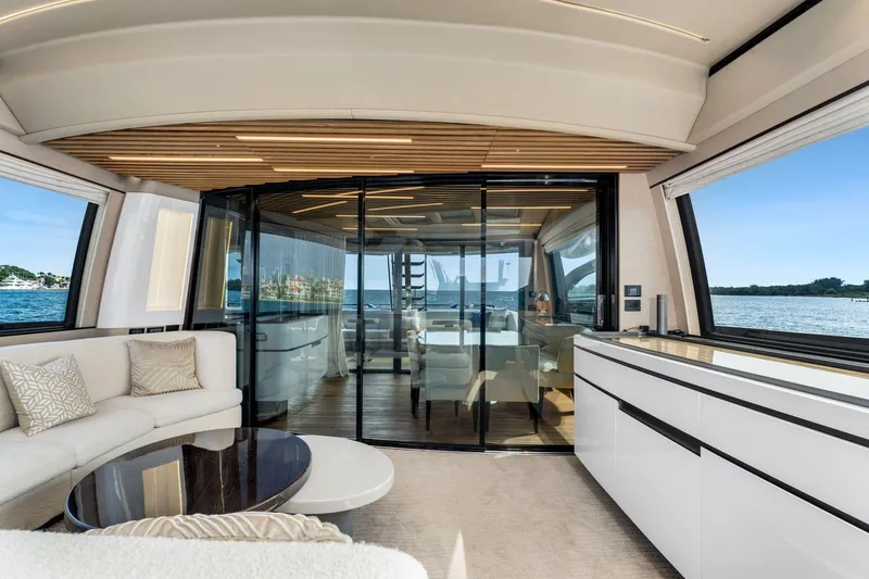 Latitude Yacht Photos Pics Luxurious interior of 2022 Azimut S10 yacht with modern furnishings and ocean view.