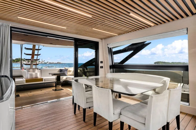 Latitude Yacht Photos Pics Luxurious interior of 2022 Azimut S10 yacht with ocean view and elegant dining area.