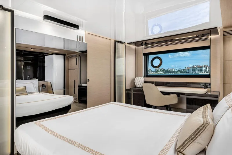 Latitude Yacht Photos Pics Luxurious bedroom interior of 2022 Azimut S10 yacht with scenic ocean view.