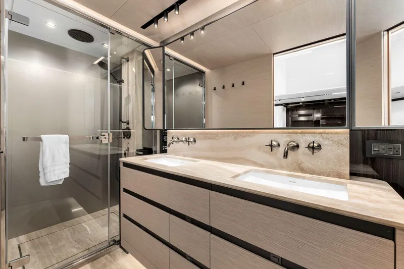 Latitude Yacht Photos Pics Luxurious bathroom in 2022 Azimut S10 yacht with dual sinks and glass shower.