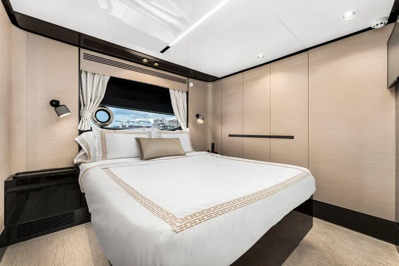 Latitude Yacht Photos Pics Luxurious bedroom interior of 2022 Azimut S10 yacht with elegant bedding and modern design.
