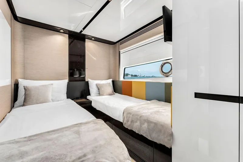 Latitude Yacht Photos Pics Luxurious 2022 Azimut S10 yacht cabin with twin beds and modern decor.