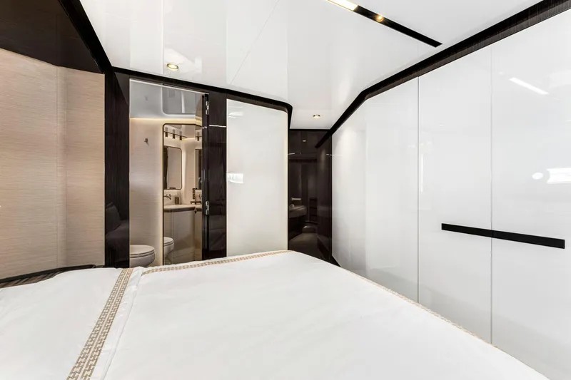 Latitude Yacht Photos Pics Luxurious interior of 2022 Azimut S10 yacht bedroom with modern design and ensuite bathroom.