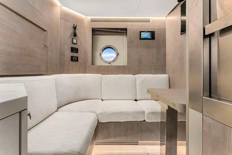 Latitude Yacht Photos Pics Luxurious interior of 2022 Azimut S10 yacht with cozy seating and modern design.