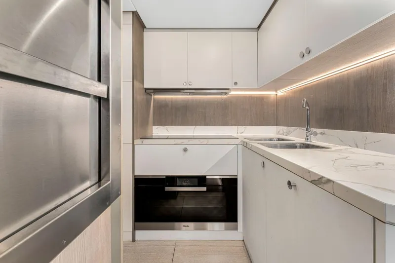 Latitude Yacht Photos Pics Modern kitchen in 2022 Azimut S10 yacht with sleek cabinetry and marble countertops.