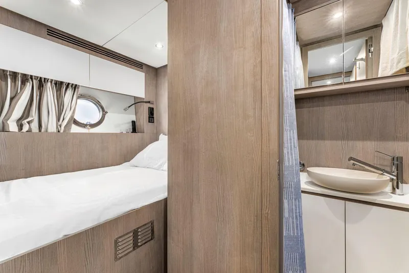 Latitude Yacht Photos Pics Luxurious 2022 Azimut S10 yacht interior with cozy bed and modern bathroom.