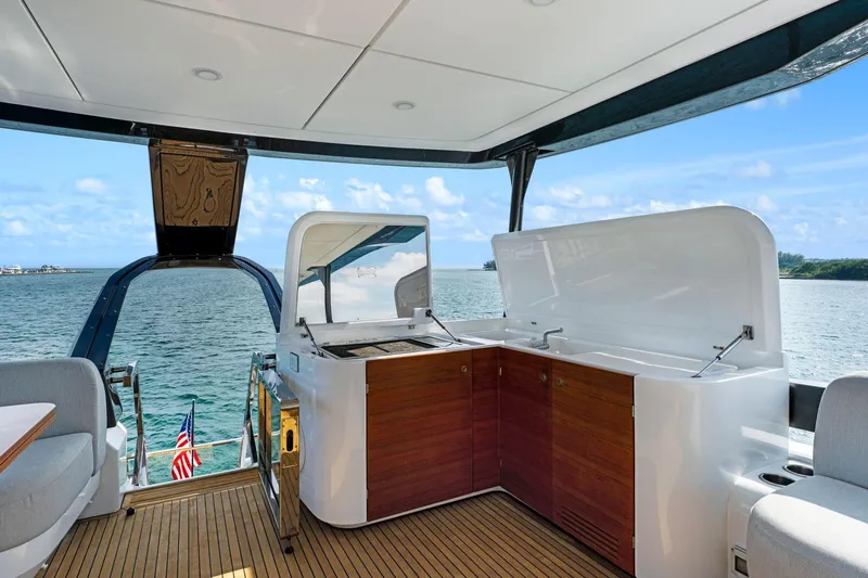 Latitude Yacht Photos Pics Luxurious 2022 Azimut S10 yacht deck with outdoor kitchen and ocean view.