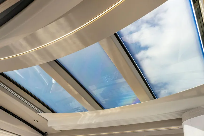 Latitude Yacht Photos Pics Skylight view from 2022 Azimut S10 yacht, showcasing modern design and clear blue sky.