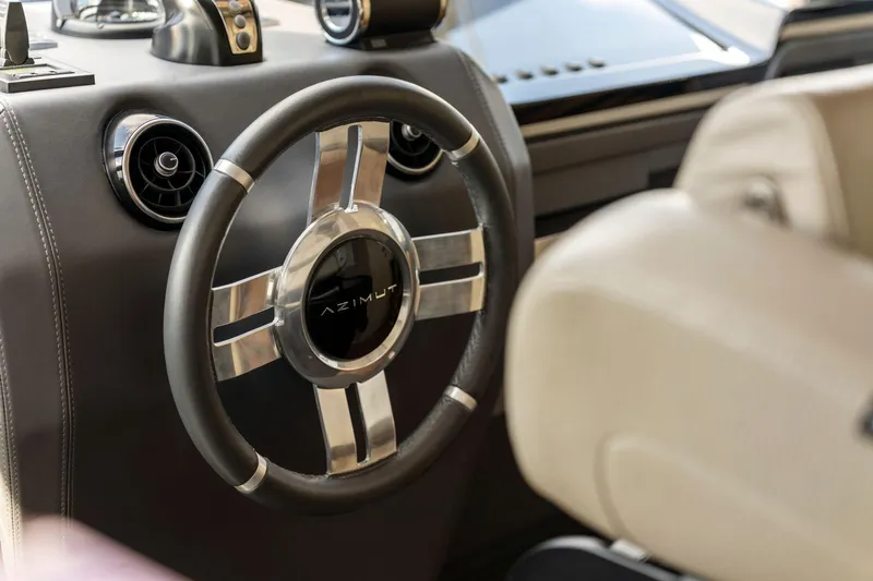 Latitude Yacht Photos Pics Steering wheel of 2022 Azimut S10 yacht, featuring sleek design and modern controls.