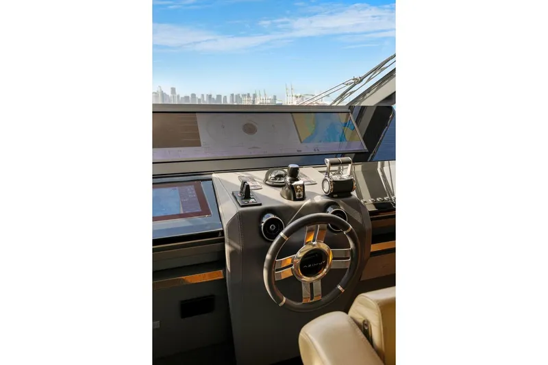 Latitude Yacht Photos Pics Cockpit of 2022 Azimut S10 yacht with modern navigation controls and city skyline view.