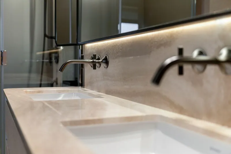 Latitude Yacht Photos Pics Luxurious bathroom sink area on 2022 Azimut S10 yacht, featuring modern fixtures.