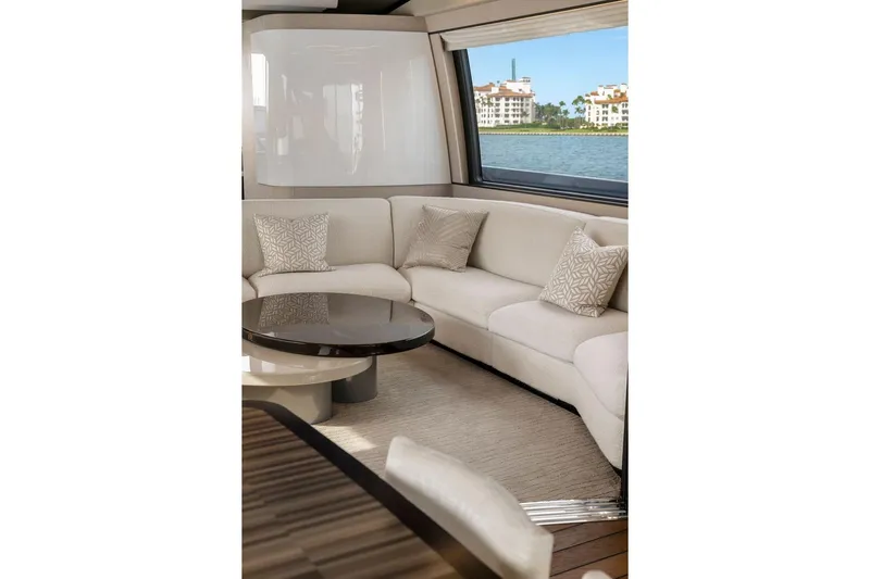 Latitude Yacht Photos Pics Luxurious interior of 2022 Azimut S10 yacht with elegant seating and scenic window view.