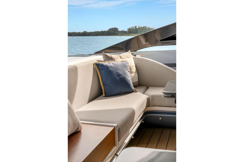 Latitude Yacht Photos Pics Luxurious seating area on 2022 Azimut S10 yacht with cushions, overlooking serene water.