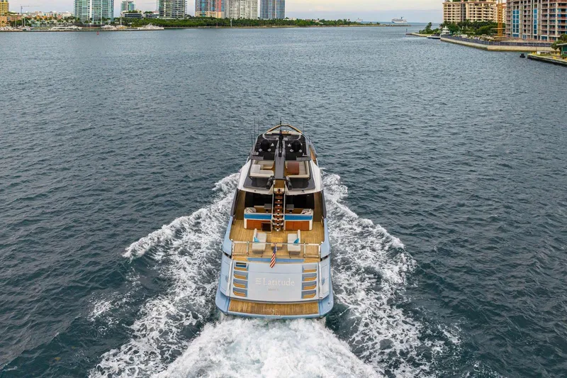 Latitude Yacht Photos Pics 2022 Azimut S10 yacht cruising in a scenic coastal waterway.