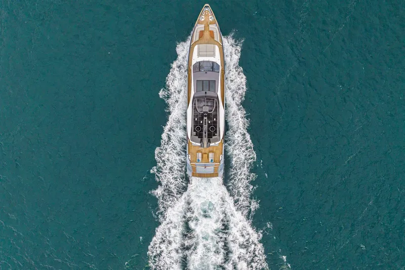 Latitude Yacht Photos Pics Aerial view of 2022 Azimut S10 yacht cruising on blue ocean waters.