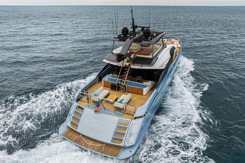 Latitude Yacht Photos Pics Azimut S10 2022 luxury yacht cruising on open sea, rear view.