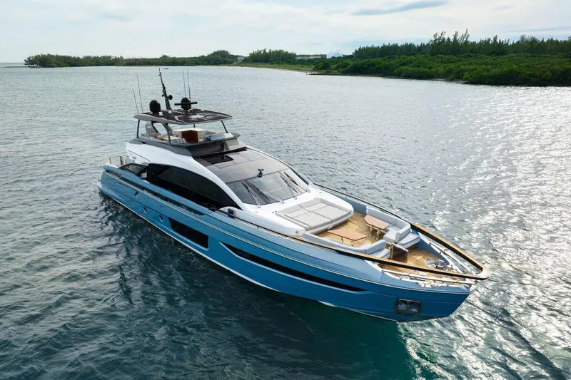 Latitude Yacht Photos Pics Luxurious 2022 Azimut S10 yacht cruising on serene waters near lush greenery.