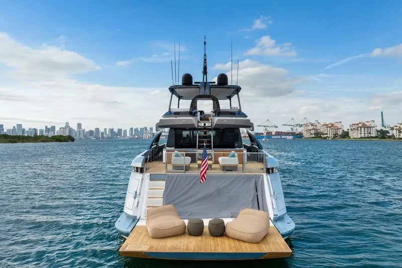 Latitude Yacht Photos Pics 2022 Azimut S10 yacht on water with city skyline in background.