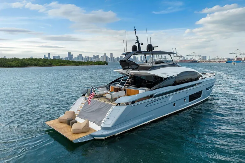 Latitude Yacht Photos Pics Luxurious 2022 Azimut S10 yacht cruising near city skyline and harbor.