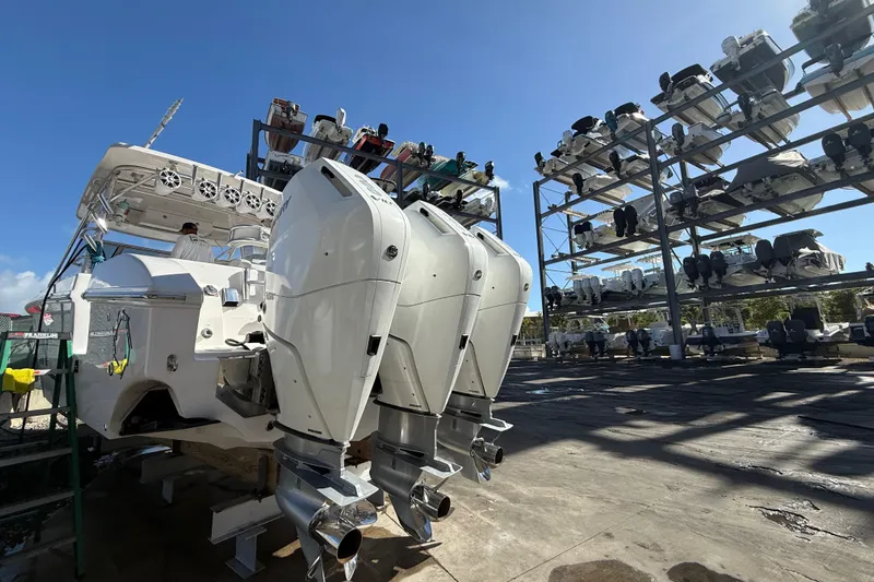  Yacht Photos Pics 2017 Fountain 38 Sportfish Cruiser with triple outboard engines in a boat storage facility.