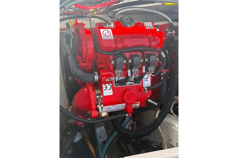  Yacht Photos Pics Red engine of a 2017 Fountain 38 Sportfish Cruiser, showcasing detailed components.