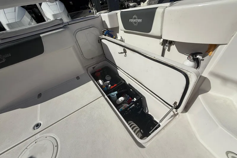  Yacht Photos Pics 2017 Fountain 38 Sportfish Cruiser storage compartment with various boating supplies.