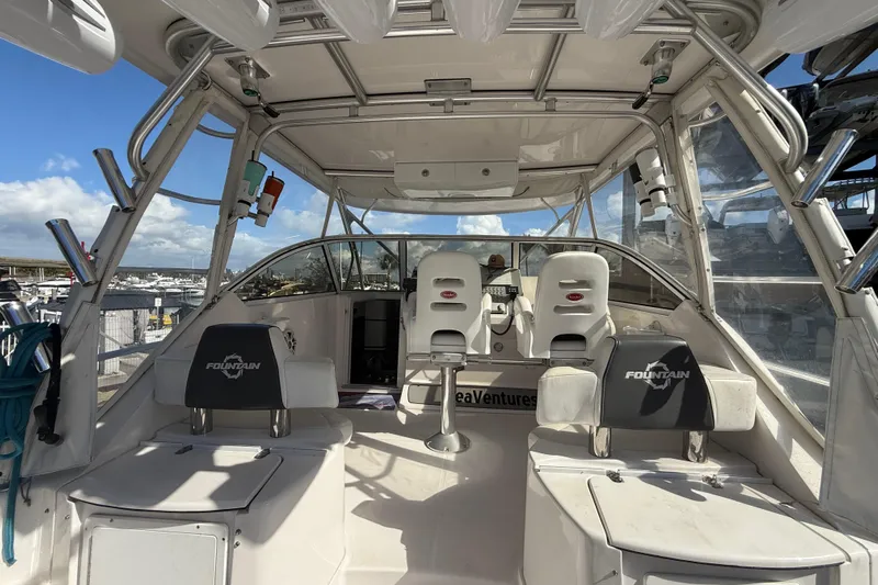  Yacht Photos Pics 2017 Fountain 38 Sportfish Cruiser interior with seating and helm, docked under clear skies.