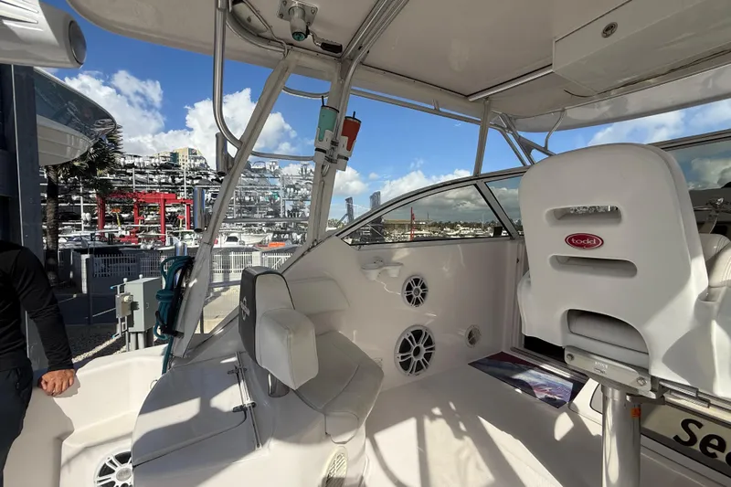  Yacht Photos Pics 2017 Fountain 38 Sportfish Cruiser interior with seating and controls, docked at marina.