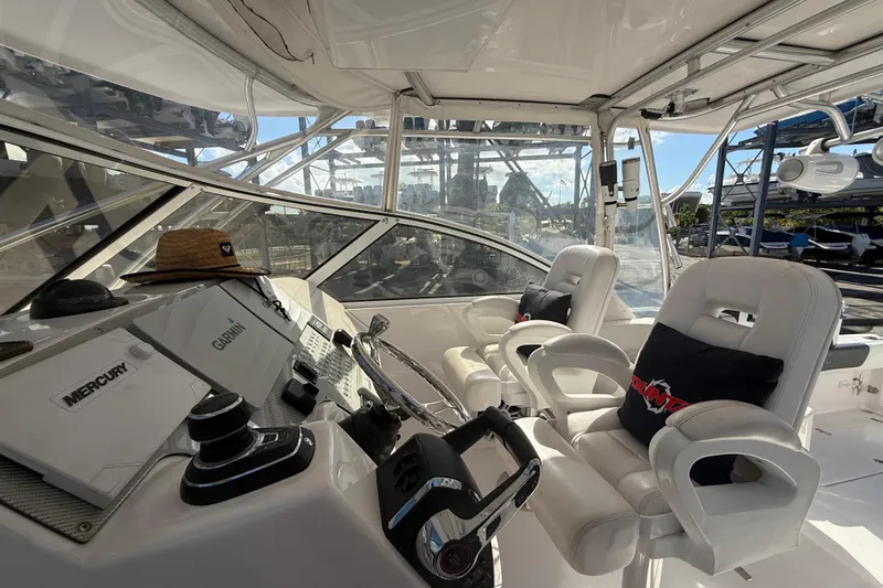  Yacht Photos Pics 2017 Fountain 38 Sportfish Cruiser cockpit with white seating and navigation equipment.