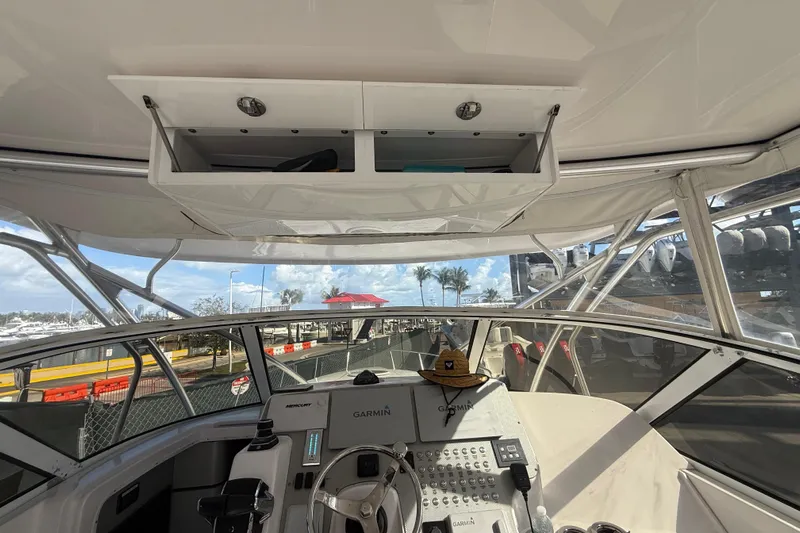  Yacht Photos Pics 2017 Fountain 38 Sportfish Cruiser helm with Garmin navigation, open storage, and marina view.
