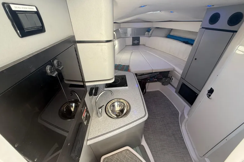  Yacht Photos Pics 2017 Fountain 38 Sportfish Cruiser interior with kitchenette and seating area.