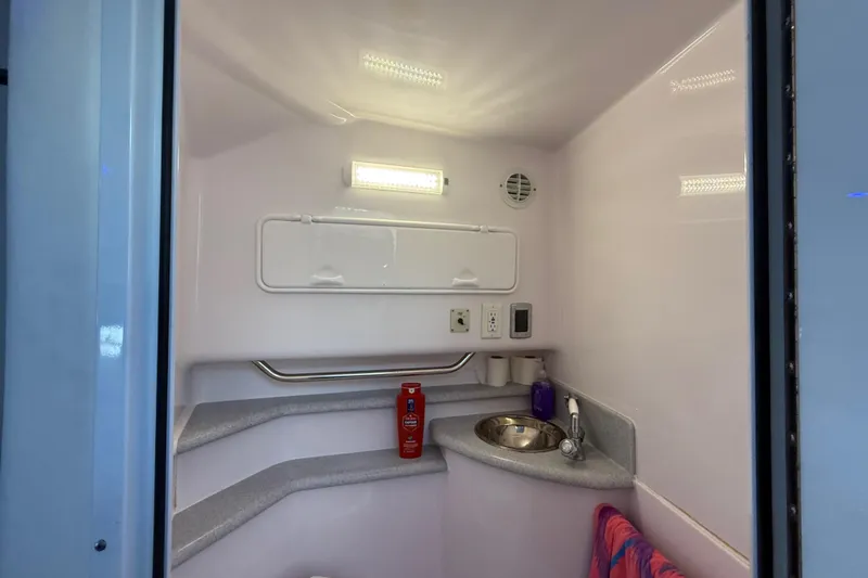  Yacht Photos Pics 2017 Fountain 38 Sportfish Cruiser bathroom with sink, towel, and toiletries.