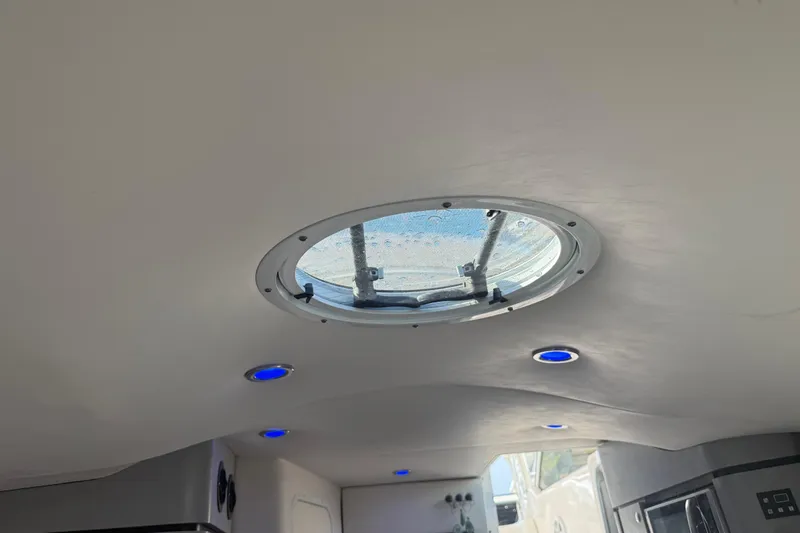  Yacht Photos Pics Ceiling view of 2017 Fountain 38 Sportfish Cruiser with round hatch and blue LED lights.