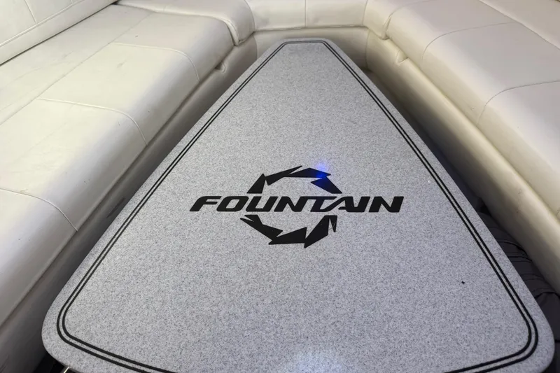  Yacht Photos Pics 2017 Fountain 38 Sportfish Cruiser interior with logo on cushioned seating.